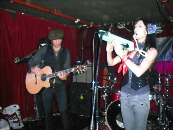 SAMI strums while KARMEN works the melodica.