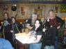 FRANKIE the KID and FUZZ watch as WILD BILL & JOHN perform HAPPY BIRTHDAY as TINA holds the cake.