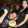 FRANKIE the KID prepares to cut the cake as STEFANY trys not to drop it.