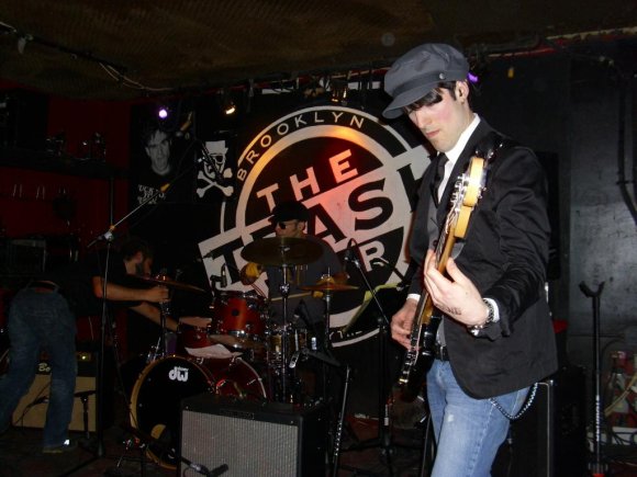 Mike fixing the cymbal while SEAN and BLAZE play on.