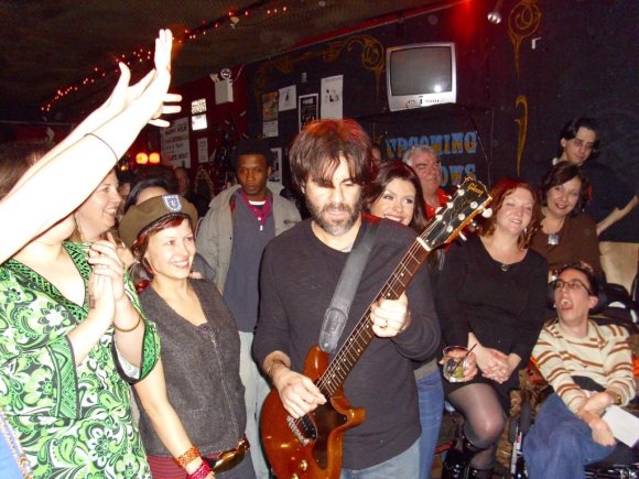 JOHN makes his way back to the stage after his foray into the crowd while RACHAEL looks over his left shoulder.