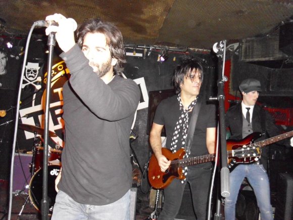 JOHN with guest guitarist NY DOLLS' STEVE CONTE and BLAZE in the background.