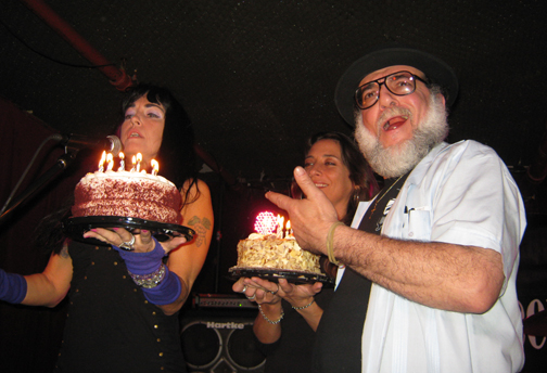 PURPLE PAM & BABS bring the cakes (that ALAN RAND brought) to Mr. WOOD.