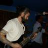 BEN on 8 string guitar with MAURICE in the shadows.