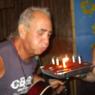 COSMO blowing out the candles on his 65th birthday cake (held by CHEALSEA AWFUL)!