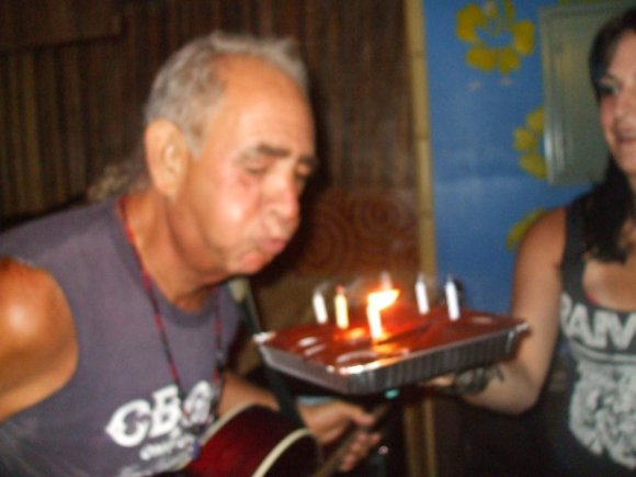 COSMO blowing out the candles on his 65th birthday cake (held by CHEALSEA AWFUL)!