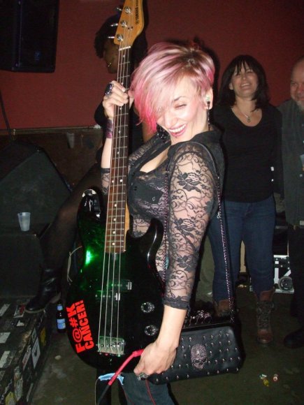 ALISON DIANE of the DOUBLE DOWN SALOON, NYC, holds RUCKUS' Bass while he's off doing ....Something!