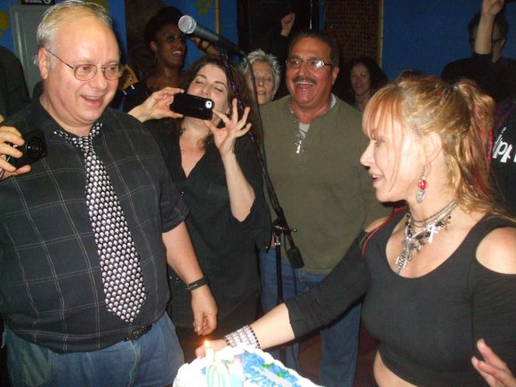 Everyone's watching as alan gets ready to blow out the candles!