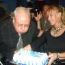 ALAN blows out the candles as CYNDI steadies the cake!