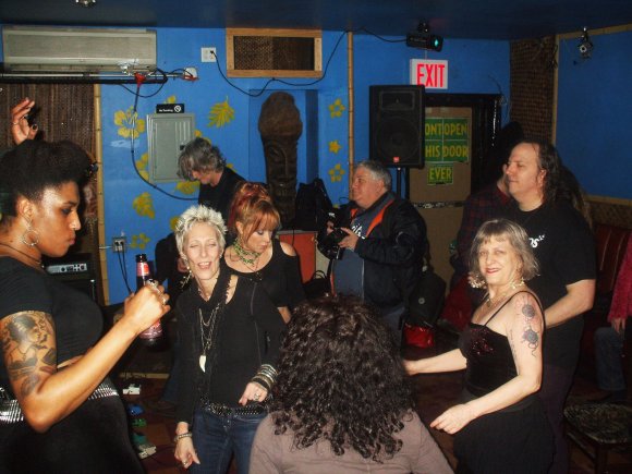 DAVID plays in the background with SIMKO next to him taking pics as CYD, JANIS, CYNDI, FRANCINE, PHYLLISS and BRIAN KELLY dance!