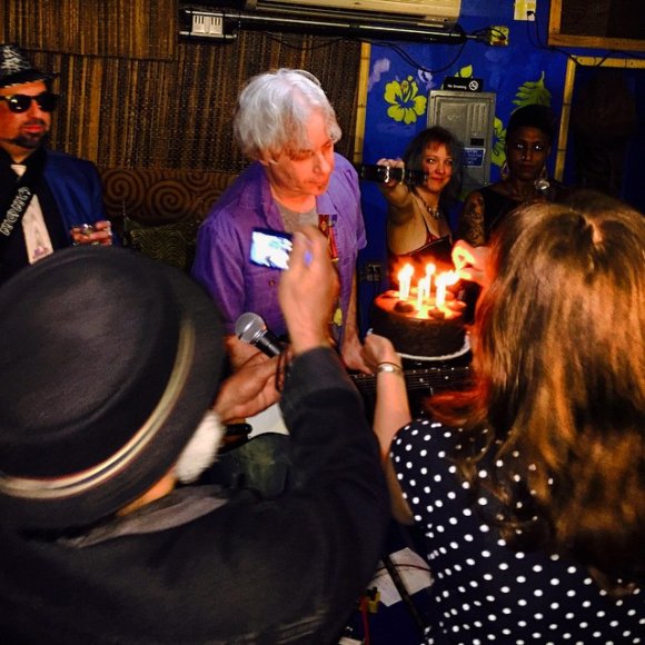 T. J. gets ready to blow out the candles as KENN, SARAH and CYD watch from behind!