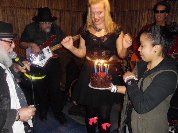 MOXIE presents the cake as Mr. WOOD talks in front of ARMAND, EMMA and CHARLES!