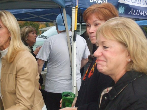 REGINA talking to CLANCY in background w/1/2 MADGE, PEGGY and LOUISE.