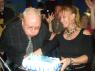 ALAN blows out the candles as CYNDI steadies the cake!